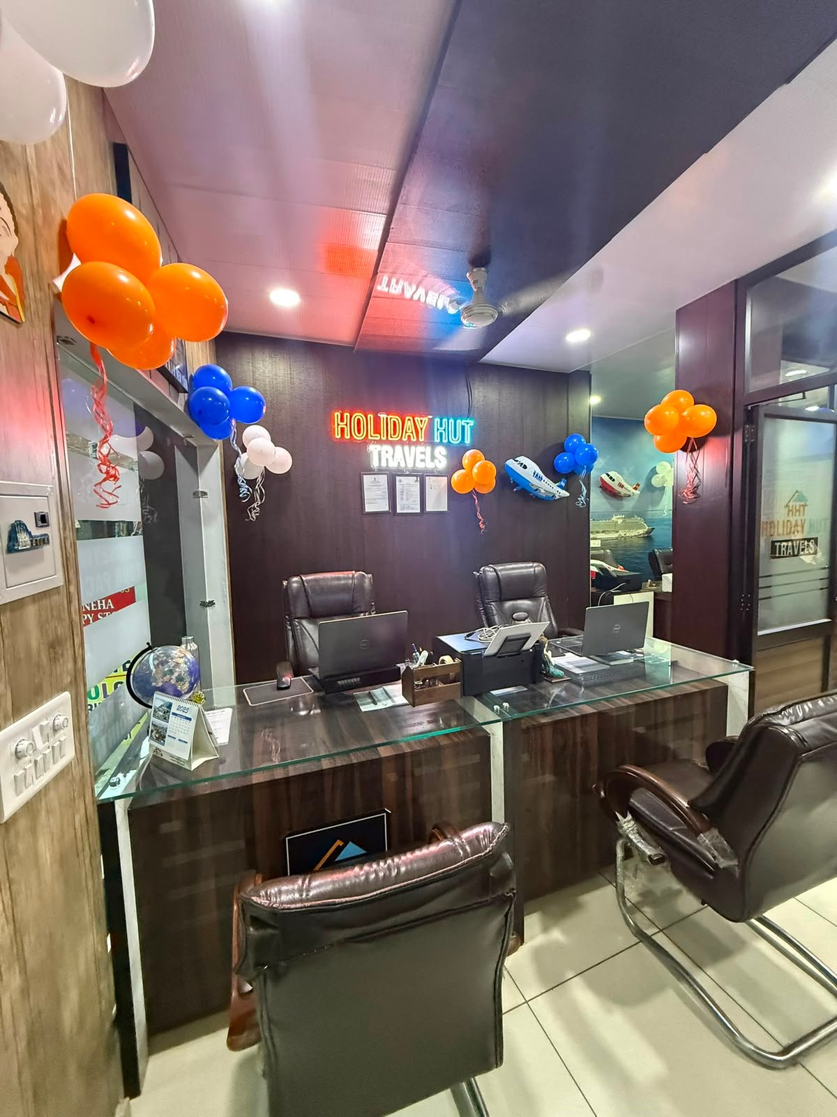 Holiday Hut Travels office interior with desks and branding
